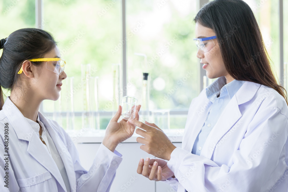 Asian young female working and research scientist together. Asian young female working and research scientist together.