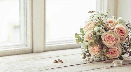 Pair of wedding rings and bridal bouquet