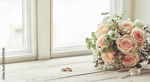 Pair of wedding rings and bridal bouquet