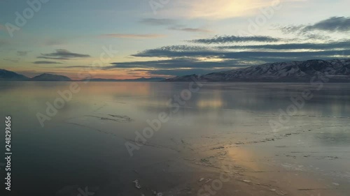 Wallpaper Mural Flying backwards over frozen lake at sunset at dusk viewing Utah Lake in winter. Torontodigital.ca