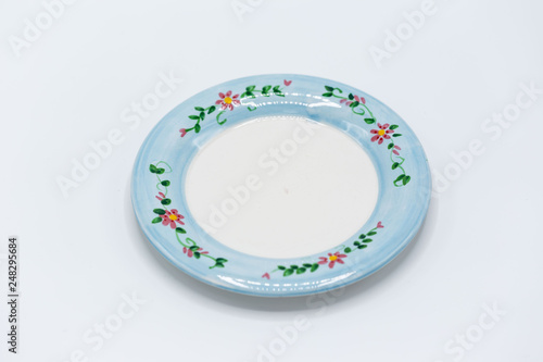 small blue and white decorative plate with small flowers on it