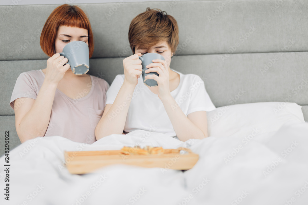 two awesome girls drinking tea at home. close up photo. copy space.healthy drink, health care