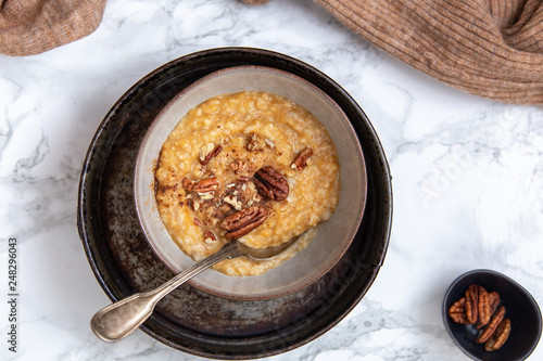 Oat porridge topped with pecan nuts and sweet Potatoes