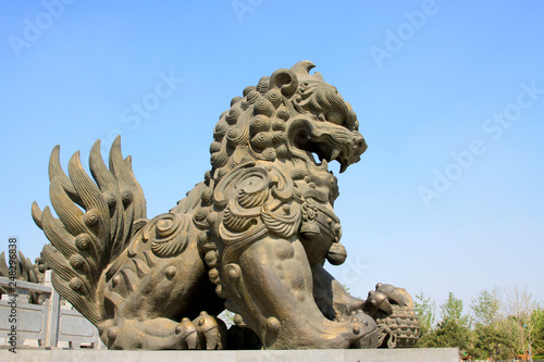 copper lion sculpture in a park  China