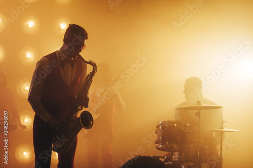 attractive musician enjoys playing the instrument atnight club, copy space, favourite job, profession photo