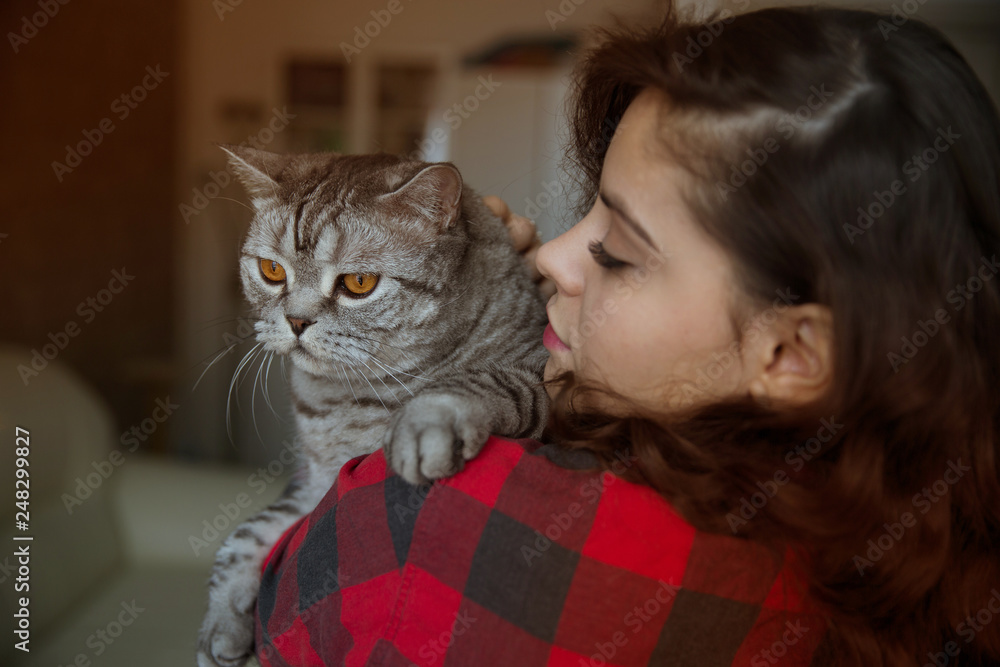 Cat on the shoulder of a young woman Cat on the shoulder of a young woman