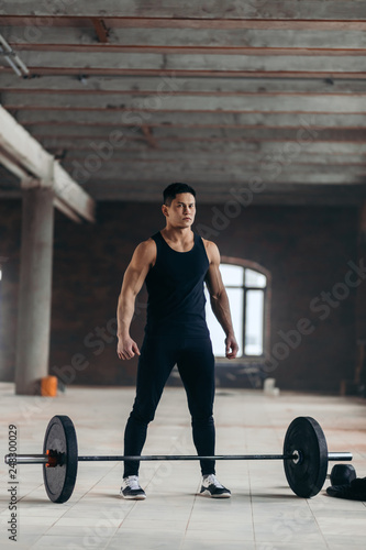 young brutal guy leads healthy lifestyle. full length photo.man is fond of powerlifting