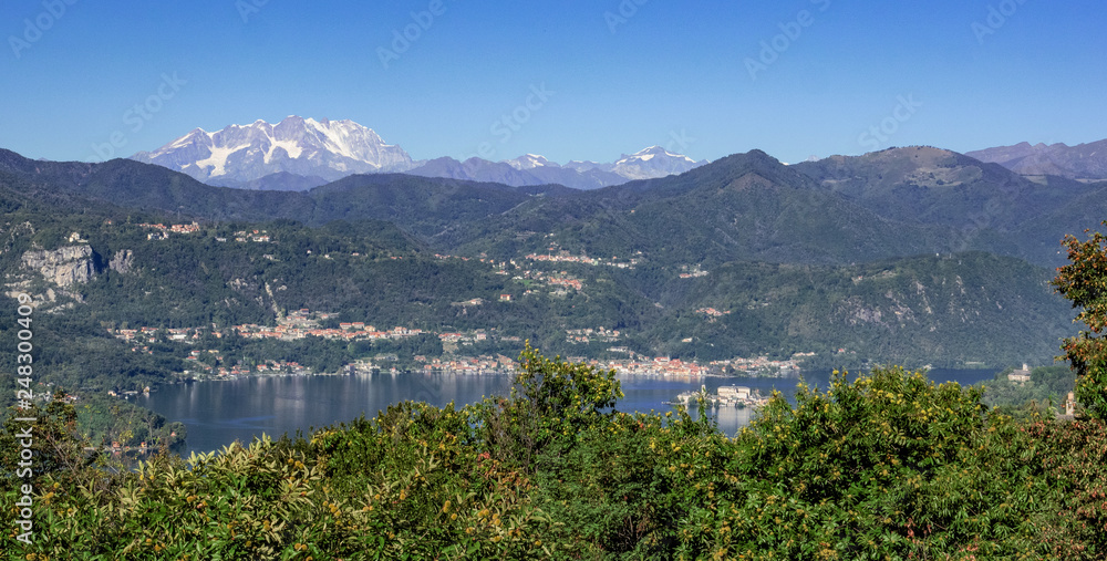 beautiful landscape of the Orta Lake surrounded by woods and snow-capped mountains, Piedmont. Italy
