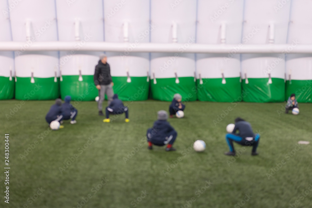 Obraz premium football training children. Football team of adorable boys exercising on green pitch on special facilities. blurry. Goalie training.