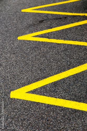 yellow lines on tarmac pavement, no-parking zone