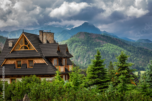Fototapeta Naklejka Na Ścianę i Meble -  Wooden cottage and clouds over Tatra Mountains, Poland