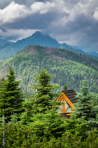 Stormy clouds over wooden cottage in Tatras, Poland photo