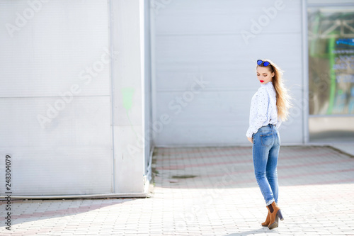 Summer, fashion and people concept - bright stylish portrait pretty woman in sunglasses against colorful wall in the city, street fashion