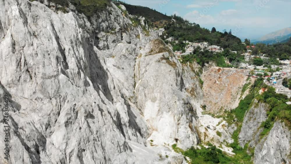 Aerial View Panning In Towards Buildings Perched On a Rocky Mountainside