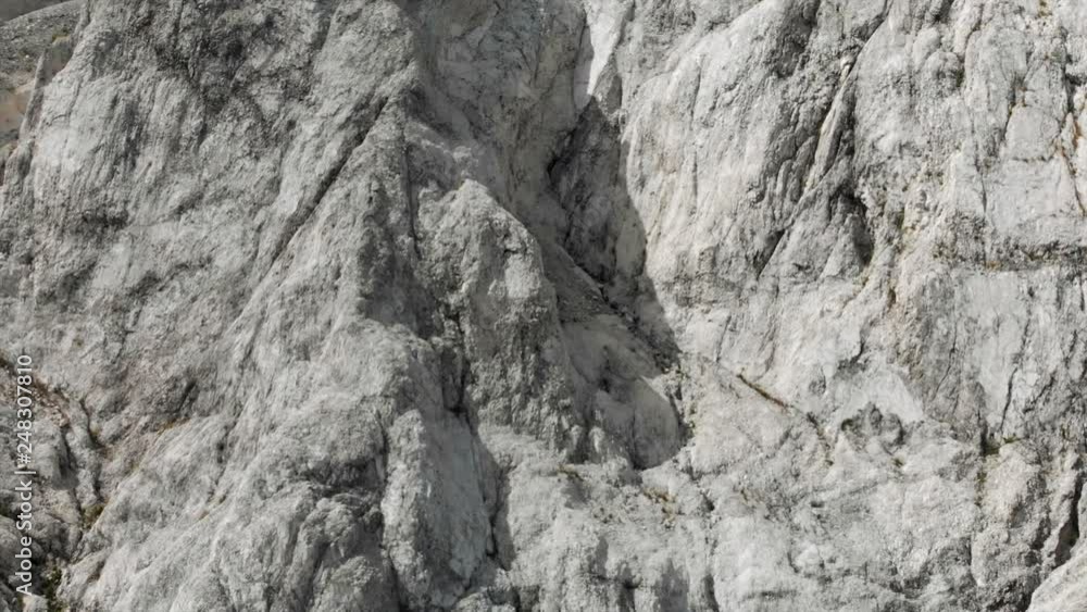Aerial View Panning Over White Rocky Textured Cliff Face Aerial View Panning Over White Rocky Textured Cliff Face