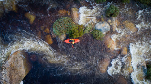 Aerial image of a white water kayaker on a mountain river in flood after good winter rains in south africa