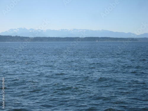 Sea and landscape with snowy mountains © Christopher
