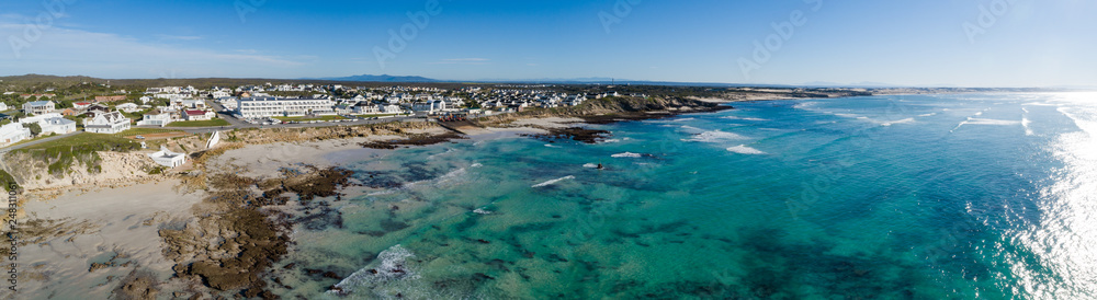 Wide angle landscape image of the dramatic sandstone rock formations along the coastline of Arniston in th Western Cape of South Africa.