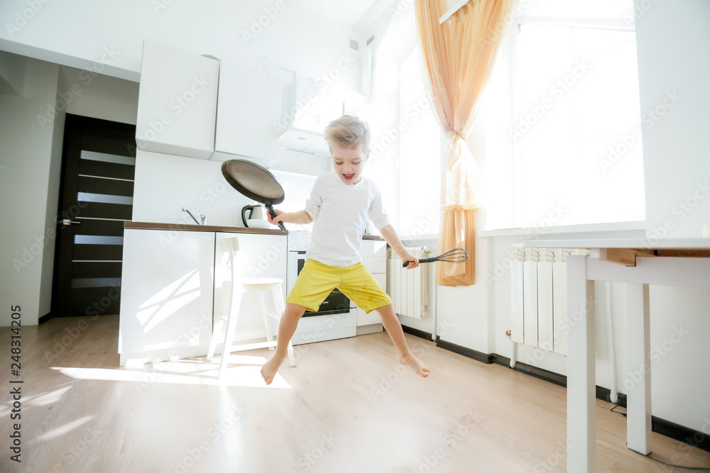 funny European little boy chef dancing,Happy weekend, boy wants to make pancakes, but the frying pan are too gay, he decided to have fun holding wooden spoons in his hands, having fun while cooking funny European little boy chef dancing,Happy weekend, boy wants to make pancakes, but the frying pan are too gay, he decided to have fun holding wooden spoons in his hands, having fun while cooking