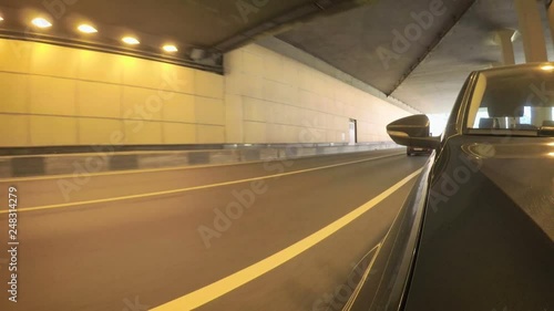 Car moves along the city street on sunny summer day. Front view from the car body.