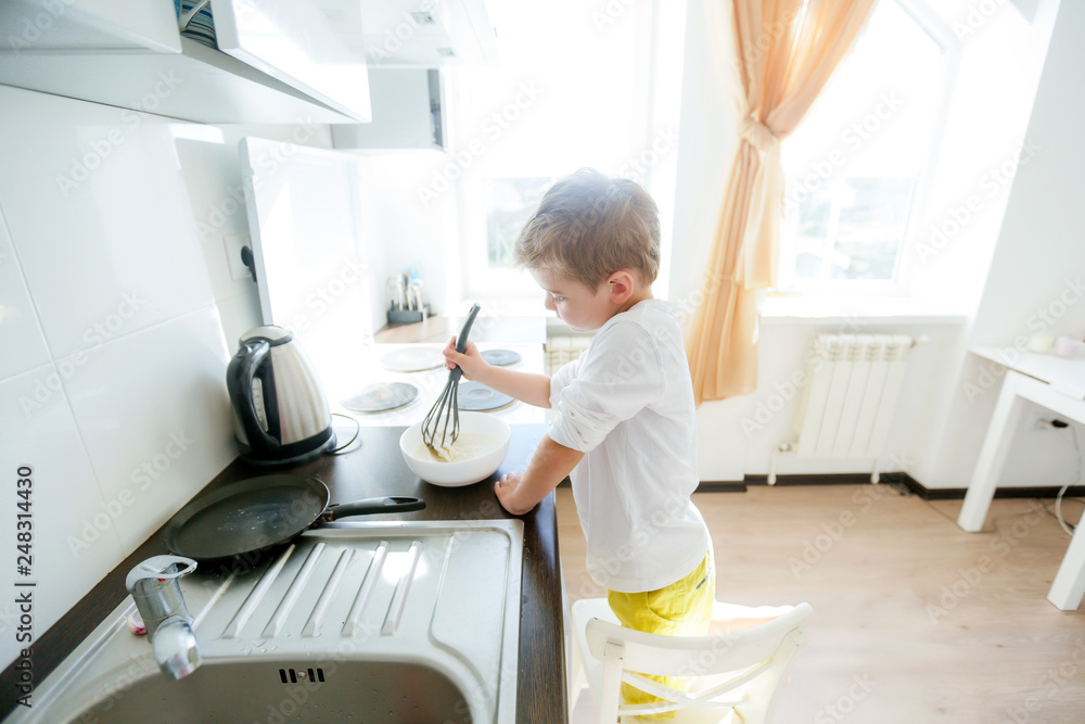 funny European little boy chef dancing,Happy weekend, boy wants to make pancakes, but the frying pan are too gay, he decided to have fun holding wooden spoons in his hands, having fun while cooking funny European little boy chef dancing,Happy weekend, boy wants to make pancakes, but the frying pan are too gay, he decided to have fun holding wooden spoons in his hands, having fun while cooking
