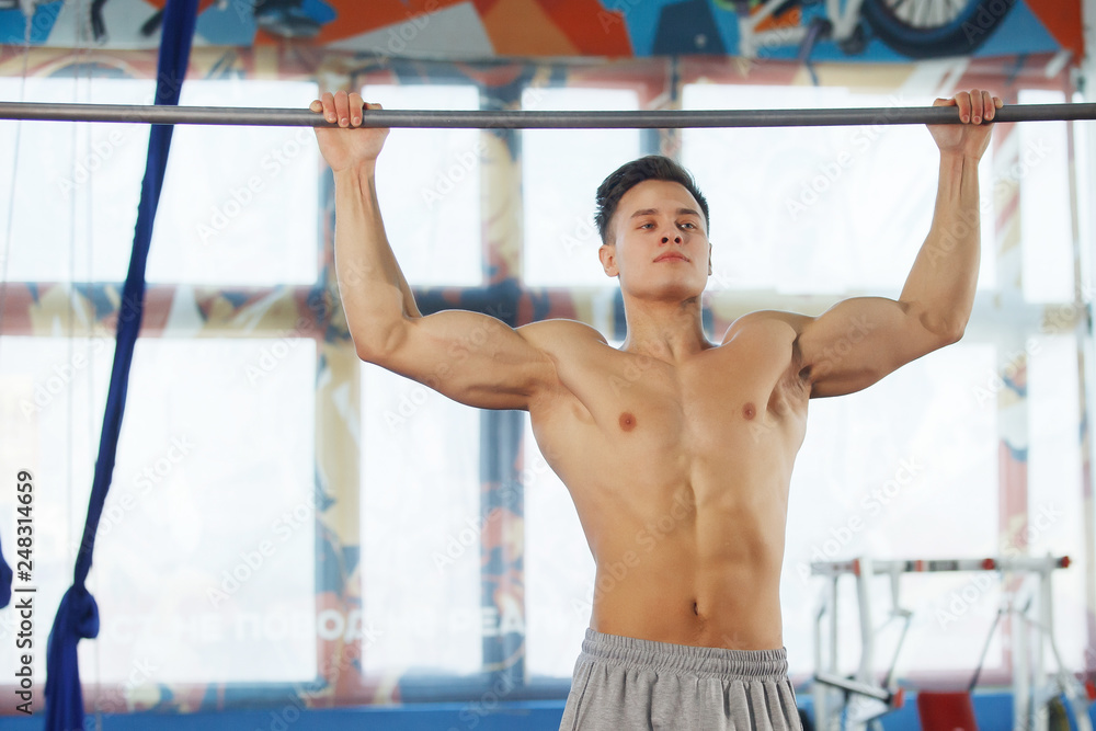 Man making exercises on crossbar. Man making exercises on crossbar.