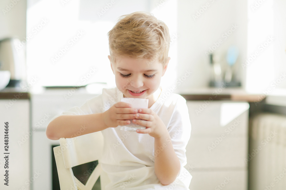 Sweet preschool child in the kitchen, making pancakes in the morning Sweet preschool child in the kitchen, making pancakes in the morning