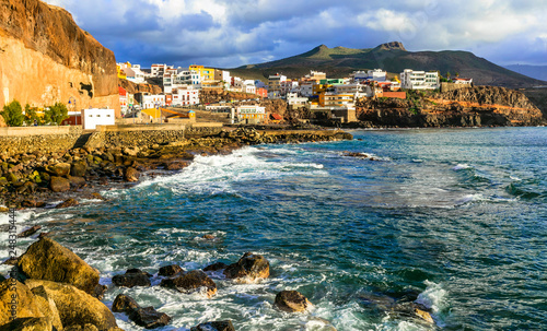 Scenery of Gran Canaria - Puerto de Sardina coastal town over sunset. Canary islands