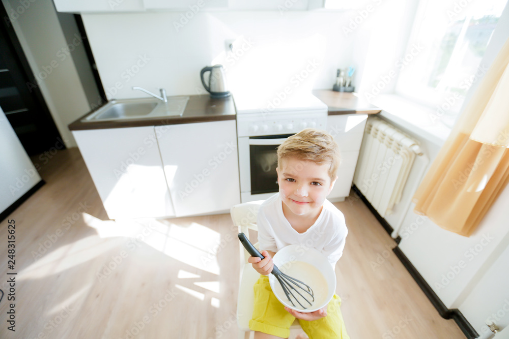 Preschool kid, help mother making pancakes in the morning, Preschool kid, help mother making pancakes in the morning,