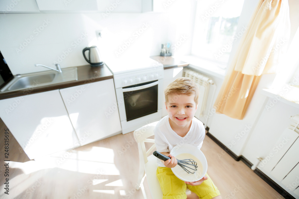 Five years boy enjoy cooking making pancakes in the morning, happy childhood Five years boy enjoy cooking making pancakes in the morning, happy childhood