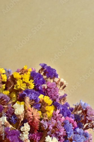 beautiful summer bouquet of natural garden flowers - limonium on beige background copy space