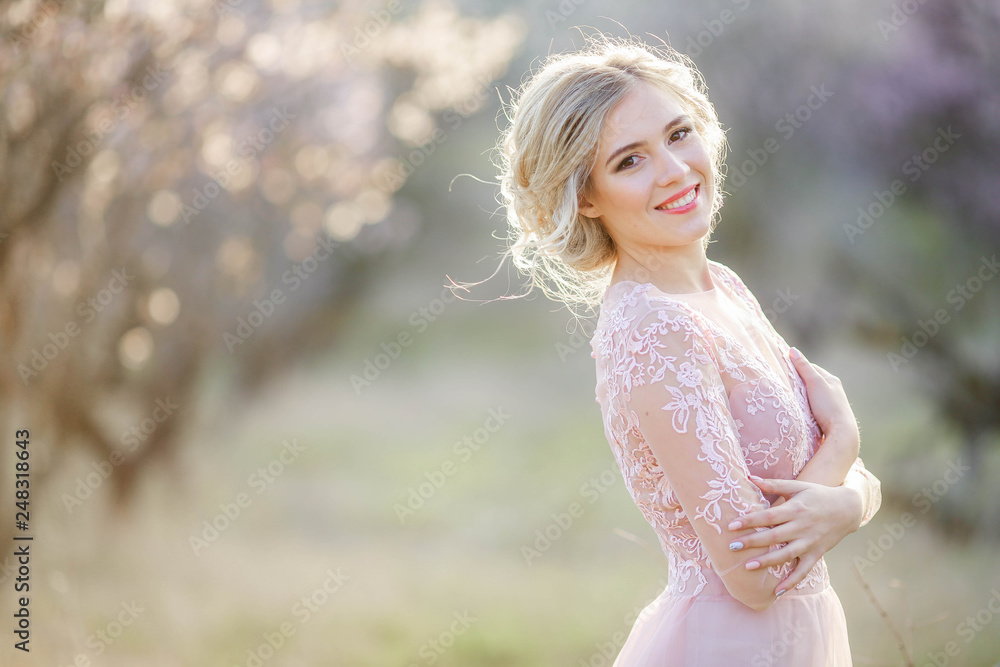 Beautiful girl wearing a bridal gown in a pink forest Beautiful girl wearing a bridal gown in a pink forest