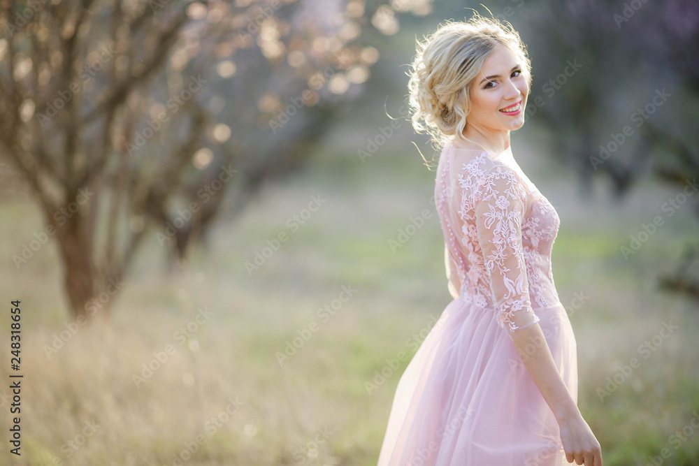 Beautiful girl wearing a bridal gown in a pink forest Beautiful girl wearing a bridal gown in a pink forest