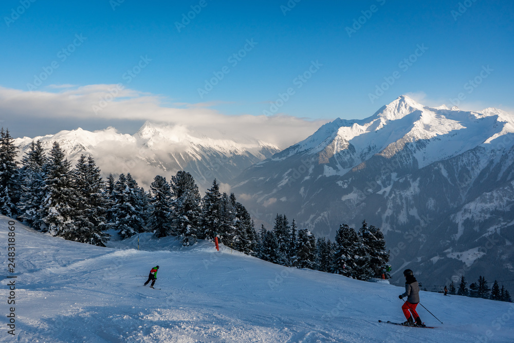 skiing during sunset in winter in the mountains