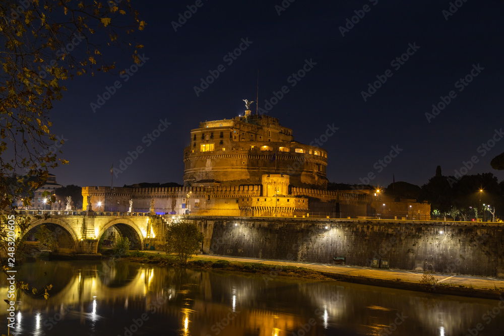 View of the Castle of St. Angelo or the Mausoleum of Hadrian and St. Angel's bridge at night, Italy