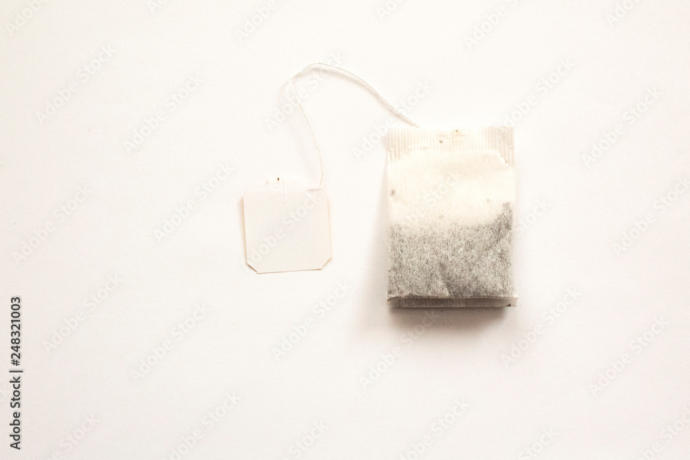 Obraz premium Teabag with red label isolated on a white