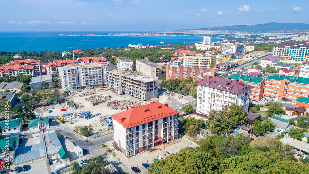New multi-storey residential building on the shore of the beautiful Gelendzhik Bay. Black sea coast of the Caucasus, resorts of Kuban. Another residential complex is being built nearby