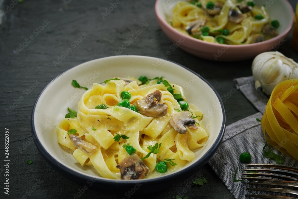 Homemade Fettuccine Alfredo with mushrooms and green peas Homemade Fettuccine Alfredo with mushrooms and green peas