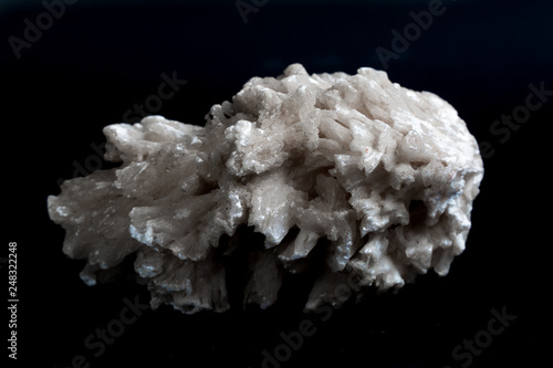 Drusus gypsum. white stone on a black background. photo