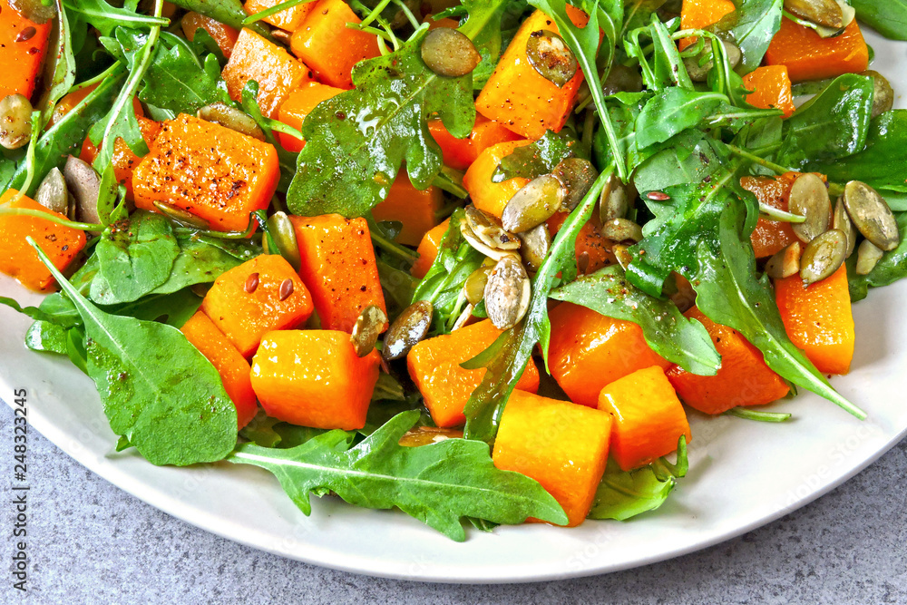 Healthy salad with arugula and pumpkin. Fitness salad. The concept of proper nutrition. Vegan pumpkin salad. Healthy salad with arugula and pumpkin. Fitness salad. The concept of proper nutrition. Vegan pumpkin salad.