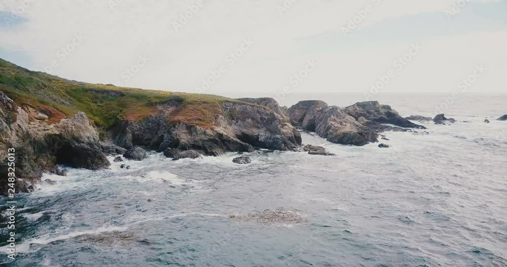Drone flying above amazing calm ocean shore with waves crashing over rocks at amazing summer Big Sur panorama California Drone flying above amazing calm ocean shore with waves crashing over rocks at amazing summer Big Sur panorama California
