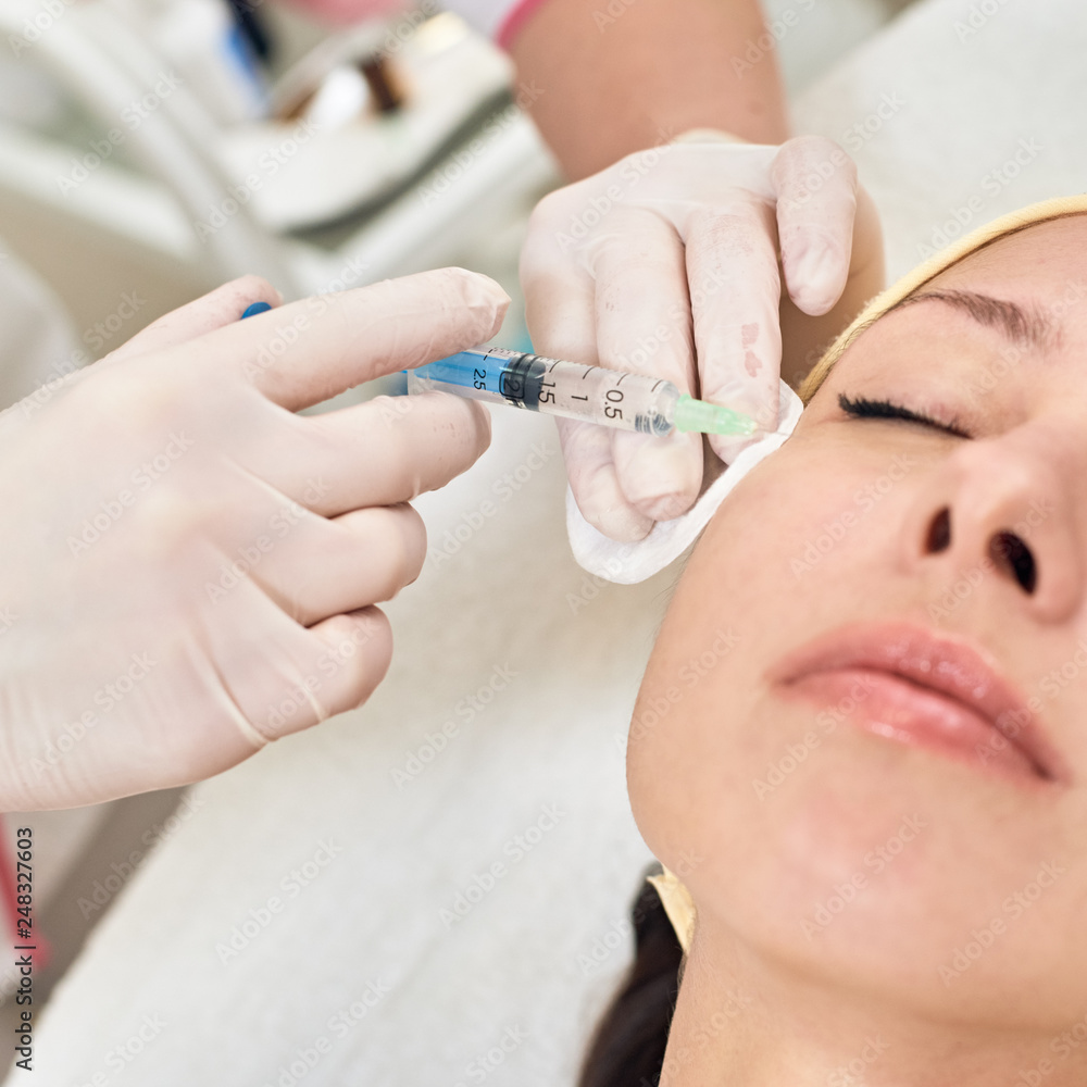Young woman getting beauty facial injections in spa salon Young woman getting beauty facial injections in spa salon