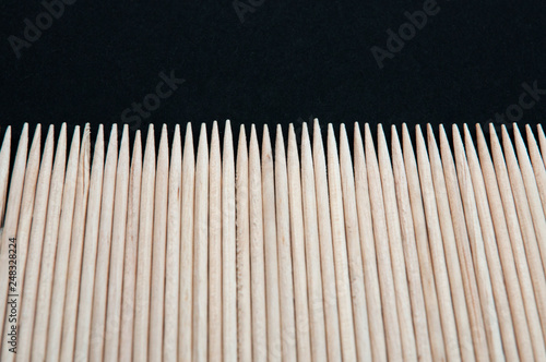 sharp wooden toothpicks are laid out in a series of top view