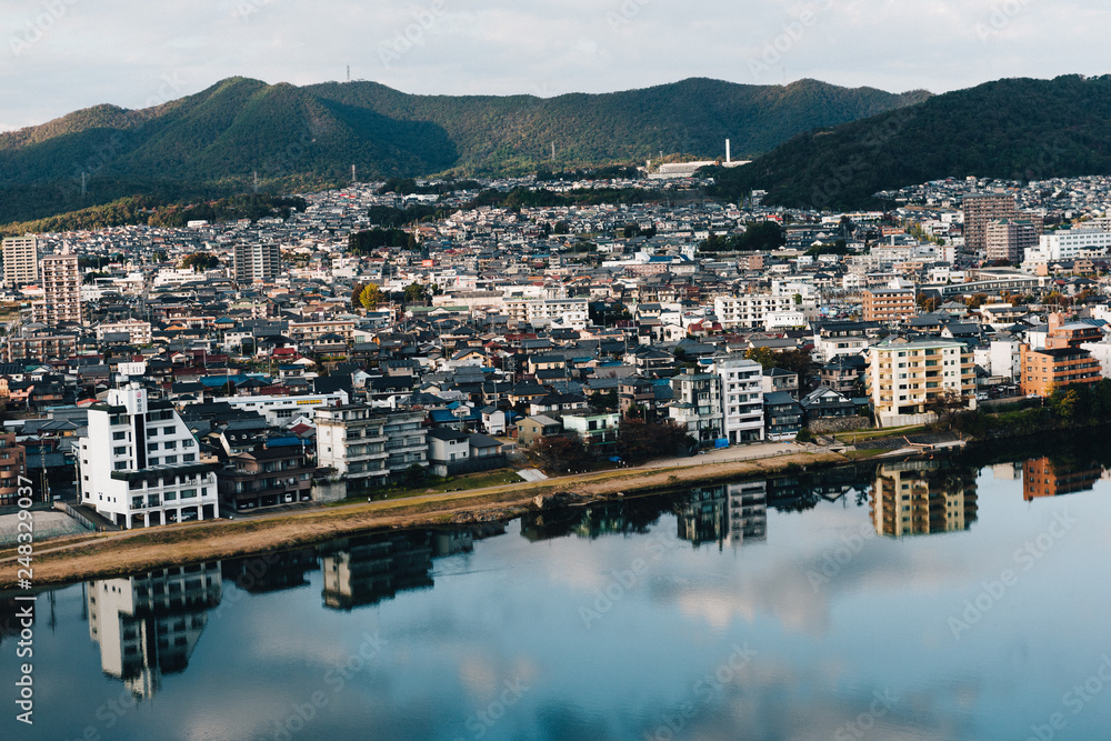 view of Kisogawa river and Inuyama cityscape in japan. Midday and clear sky. in Autumn Season.