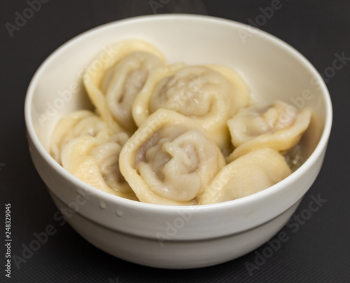 dumplings in a plate seasoning food on the table