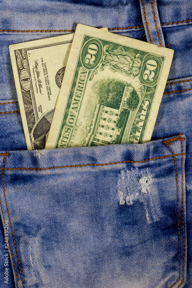 Twenty dollars bill in the pocket of blue jeans Twenty dollars bill in the pocket of blue jeans