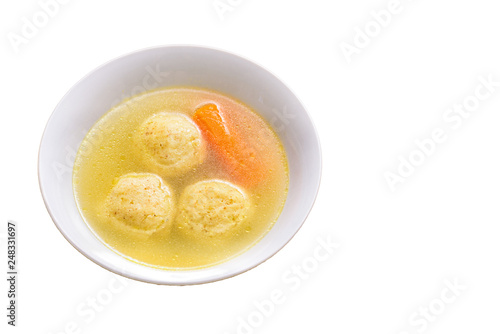 Traditional matzoh ball (kneidlach) soup.White bowl with authentic matzo ball chicken taste hot soup ( bouillon ) isolated on white background. Jewish food for Passover and every day.