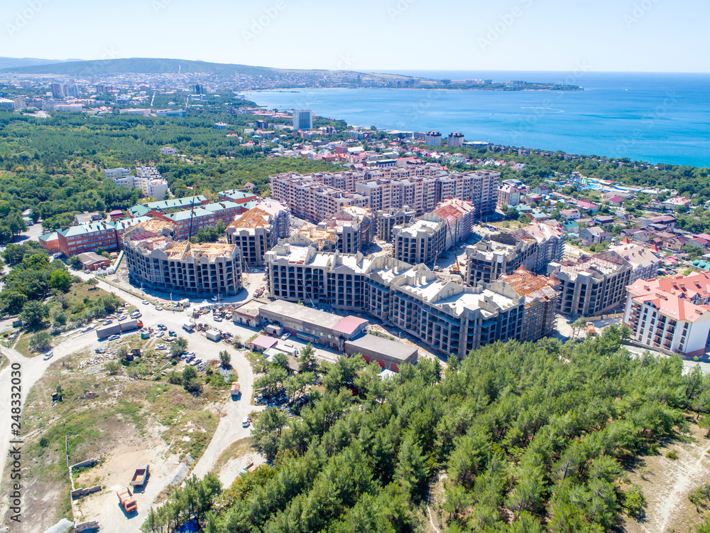 Construction of residential high-rise buildings in Gelendzhik on the shore of Gelendzhik Bay. At the foot of the Caucasus mountains on the Black sea in the resort town of Gelendzhik 