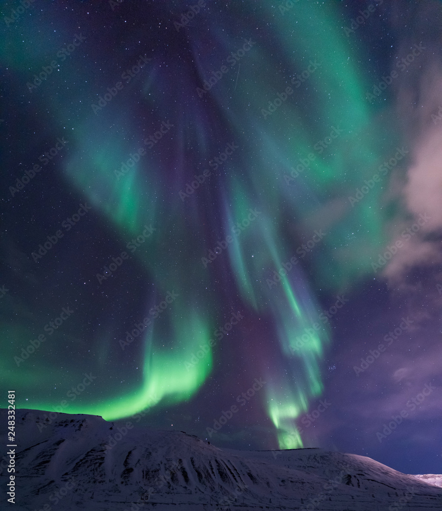 The polar arctic Northern lights aurora borealis sky star in Norway travel Svalbard in Longyearbyen city the moon mountains