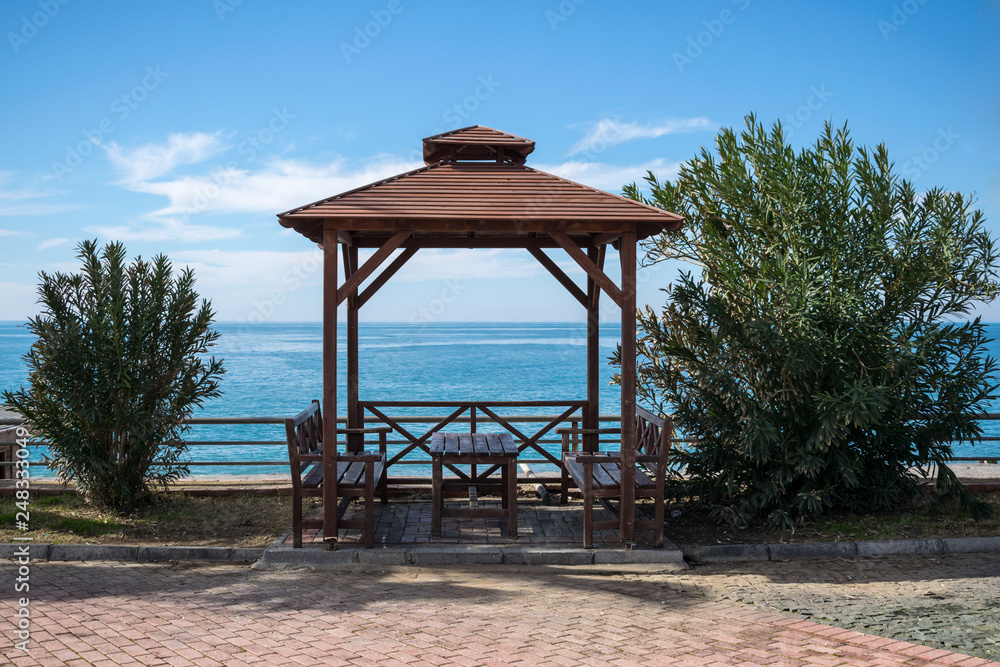 Gazebo on the seaside. Centered. Red pavement in front. Gazebo on the seaside. Centered. Red pavement in front.